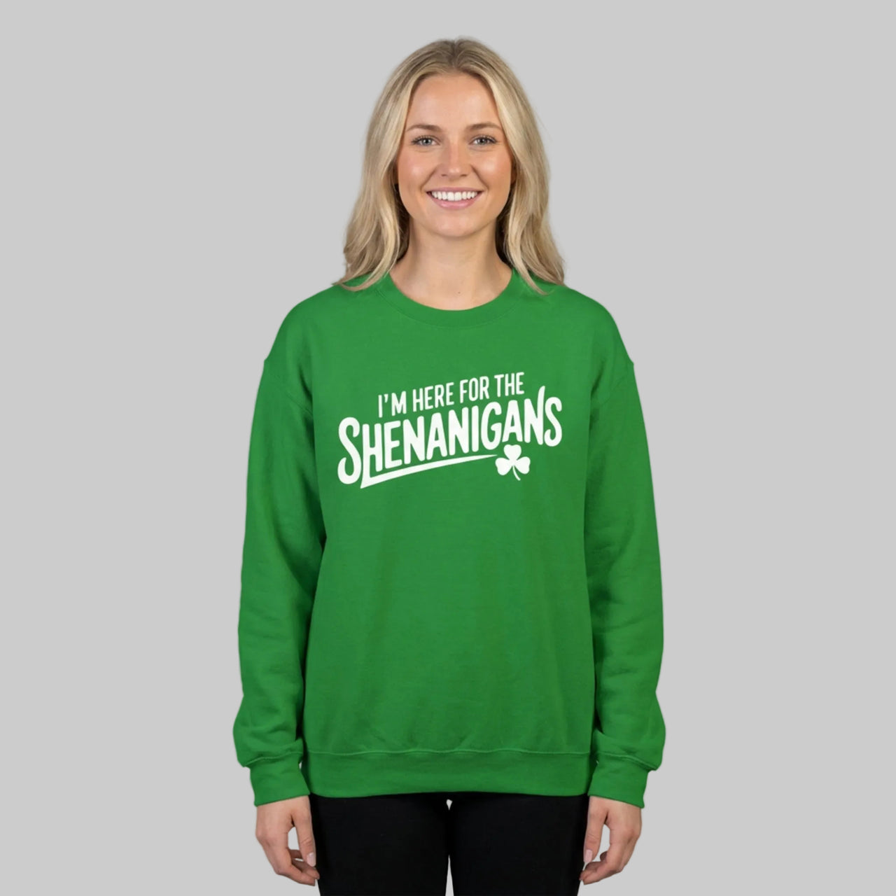 Woman wearing a green sweatshirt with the phrase 'I'm here for the Shenanigans' funny St Patricks Day design