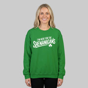Woman wearing a green sweatshirt with the phrase 'I'm here for the Shenanigans' funny St Patricks Day design