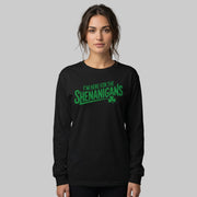 Woman wearing a black long-sleeve shirt with the phrase "I'm here for the Shenanigans" funny St Patricks Day design