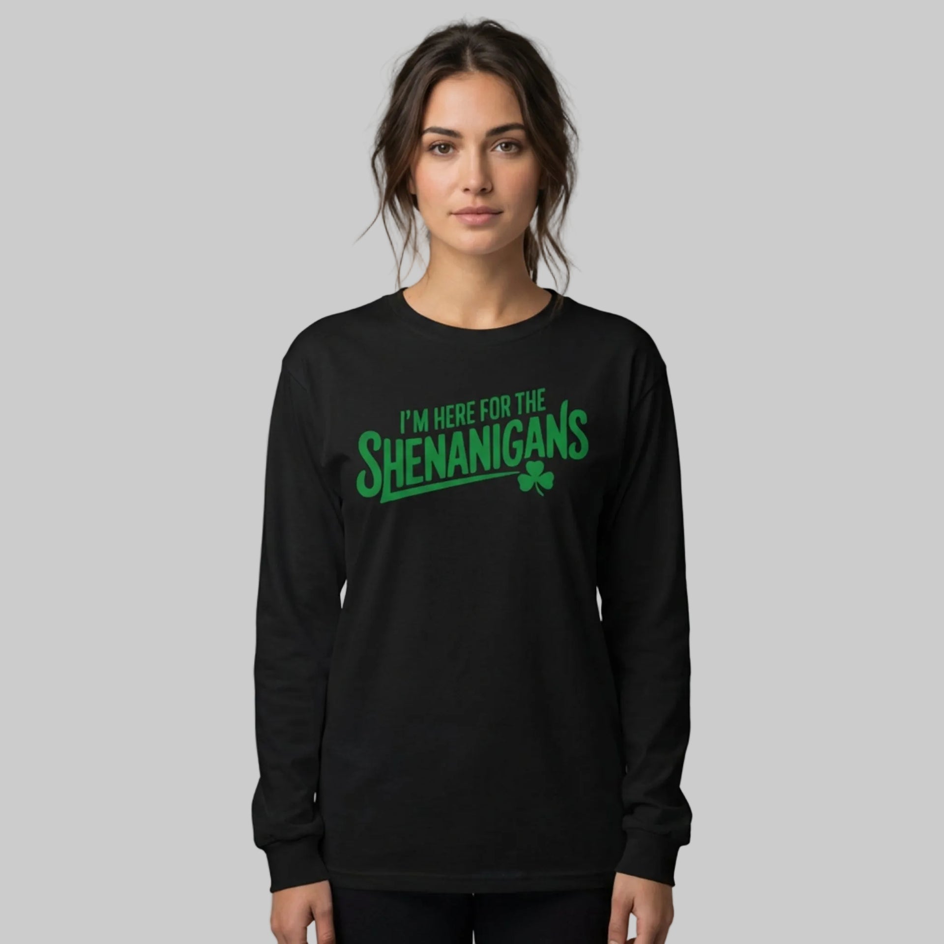 Woman wearing a black long-sleeve shirt with the phrase "I'm here for the Shenanigans" funny St Patricks Day design