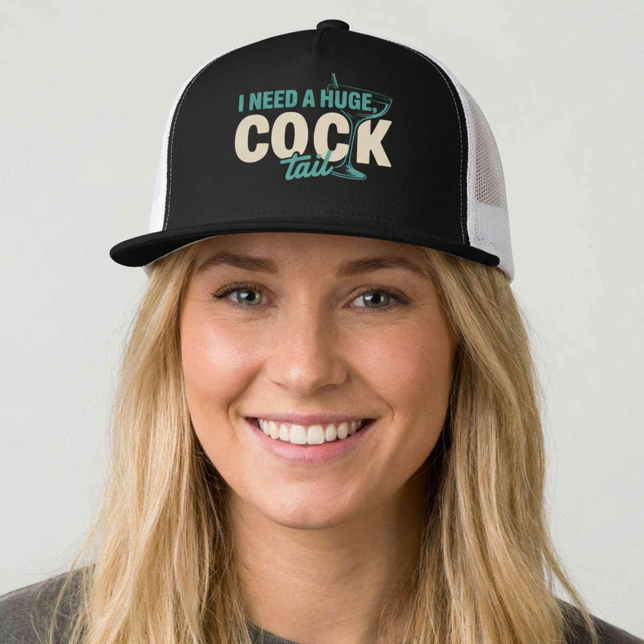 Woman wearing a black and white flat bill trucker hat with the phrase I Need a huge cocktail" funny spring break, bachelorette party, or girls trip desicgn