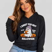 A woman wearing a black pullover hoodie with a Halloween graphic that reads 'I SHEET YOU NOT I'M SO READY FOR HALLOWEEN' around a cartoon ghost and pumpkins, against a light gray studio background.
