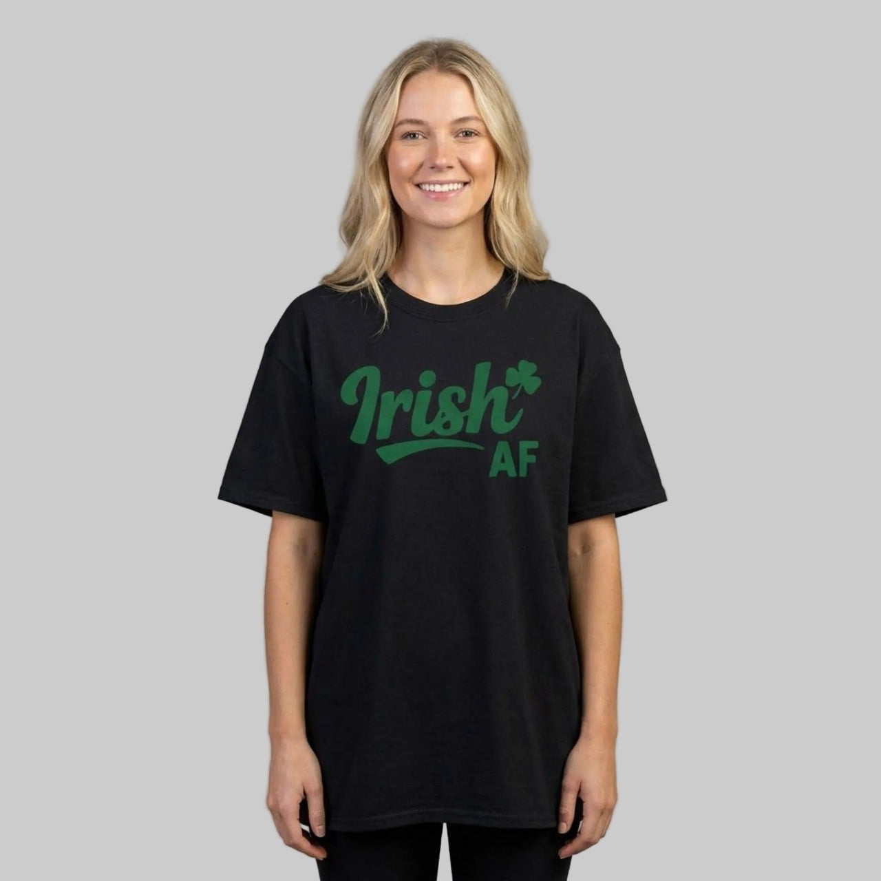 Woman wearing a black t-shirt with the phrase 'Irish AF' i funny st patricks day design