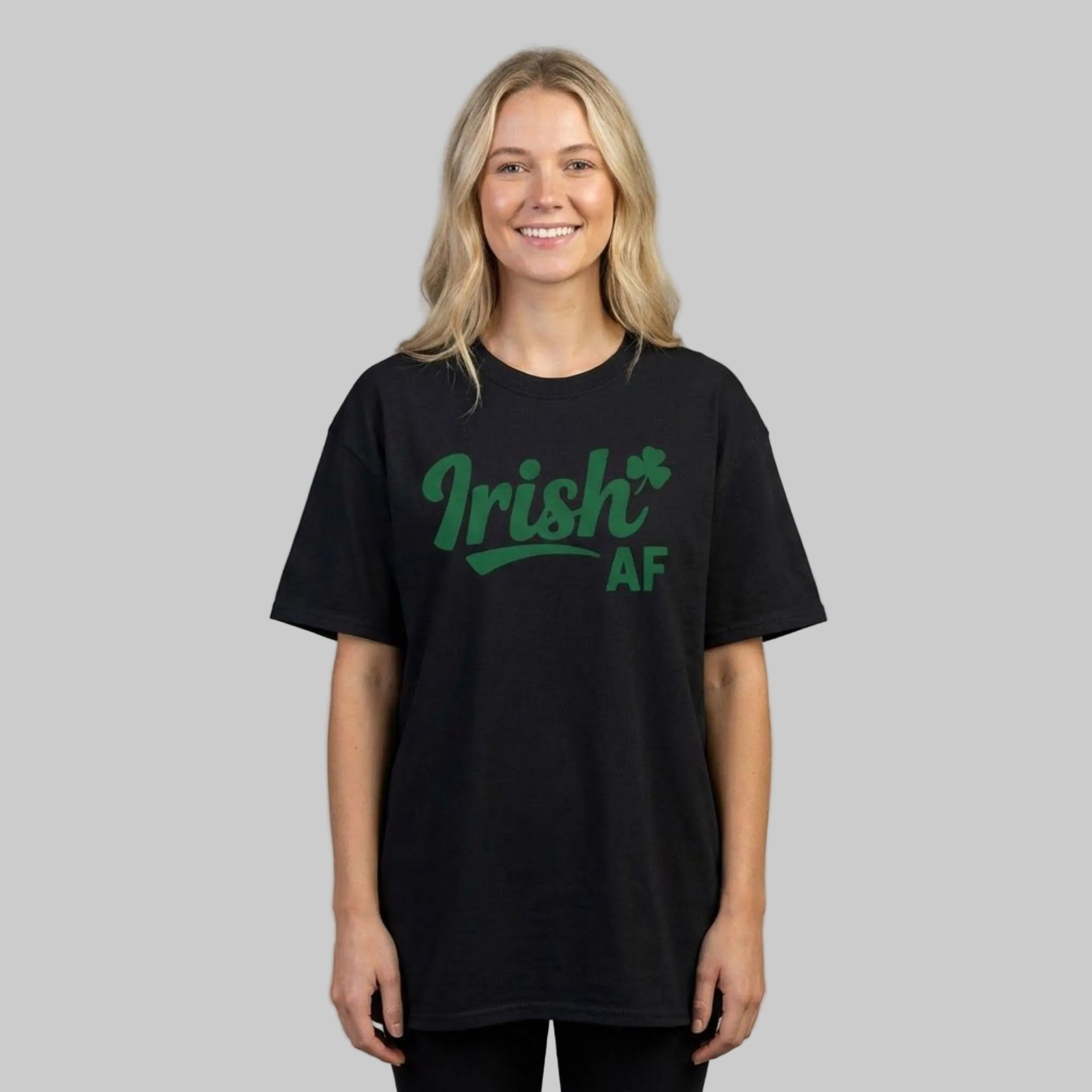 Woman wearing a black t-shirt with the phrase 'Irish AF' i funny st patricks day design