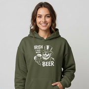 Woman wearing a green hoodie with 'Irish I Had More Beer' text and a leprechaun graphic funny St Patricks Day pub crawl and parade design