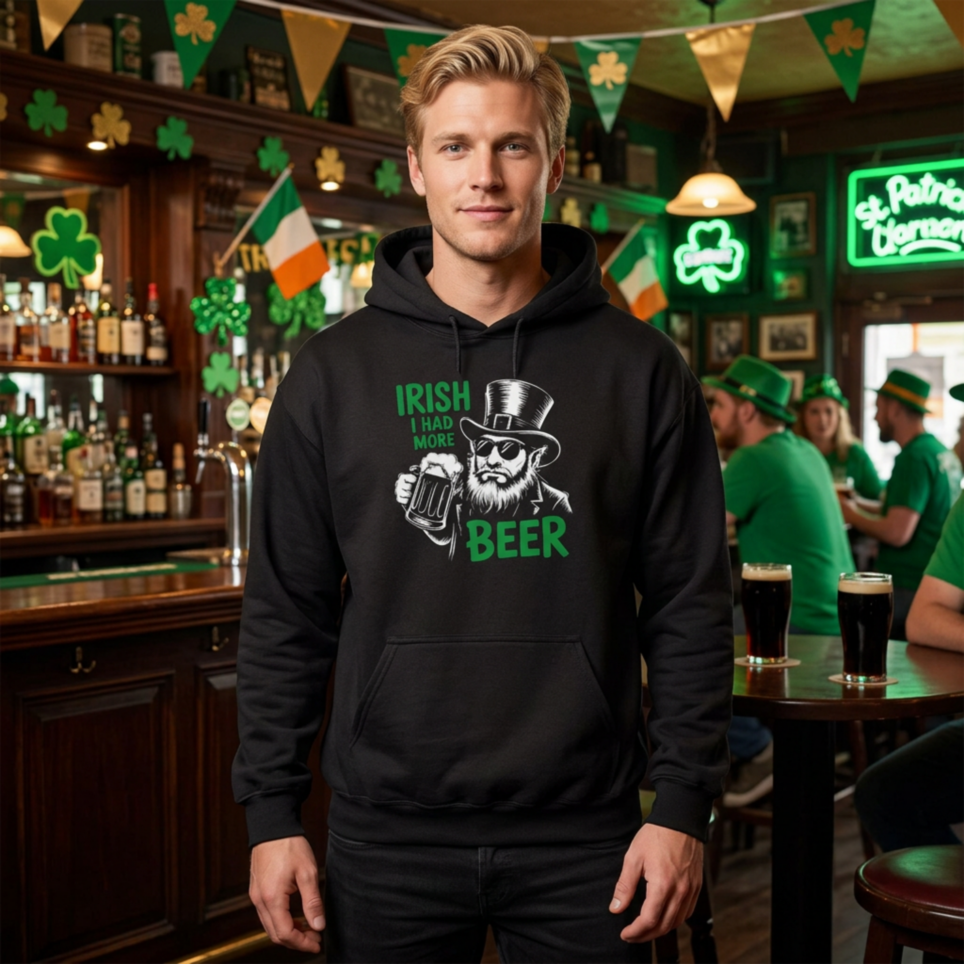 A man wearing a black hoodie with 'Irish I Had More Beer' text and a leprechaun graphic funny St Patricks Day pub crawl and parade design