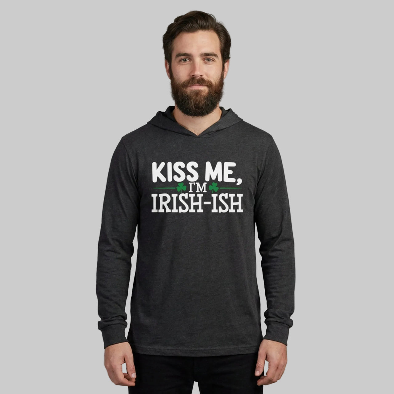 Man wearing a black hoodie with 'Kiss Me, I'm Irish-ish' text on a gray background