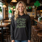 blonde female wearing a black lightweight St Patricks  Day hoodie with the Phrase “Lets Get Shamrocked”  with a leprechaun smoking a cigar
