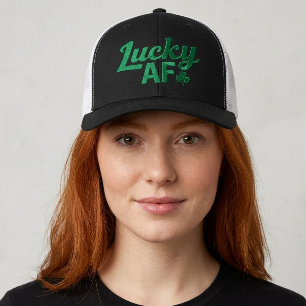 woman wearing a black curved bill trucker hat with 'Lucky AF' text funny st patricks day pub crawl design