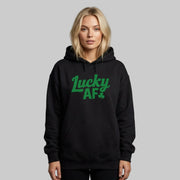 Person wearing a black hoodie with the phrase 'Lucky AF' funny St Patricks Day design
