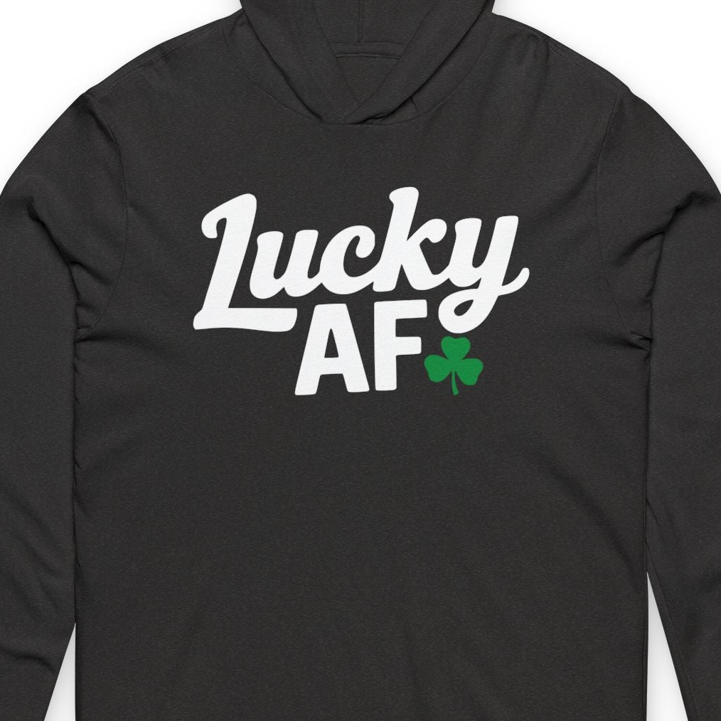zoomed in view of a blacklightweight St Patricks  Day hoodie with the Phrase “LUCKY AF”  with a shamrock to complete the design