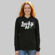 redhaired woman wearing a  lightweight St Patricks  Day hoodie with the Phrase “LUCKY AF”  with a shamrock to complete the design