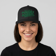 woman wearing a black and white curved bill trucker hat with 'Most Likely to Irish Goodbye' text funny st patricks day pub crawl design