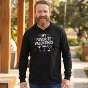 blonde bearded male model wearing featherweight hoodie with the phrase "My Favorite Valentines".  Below the Phrase are three cocktail glasses. Minimalist Valentines Heart outlines surround the the phrase to complete the design
