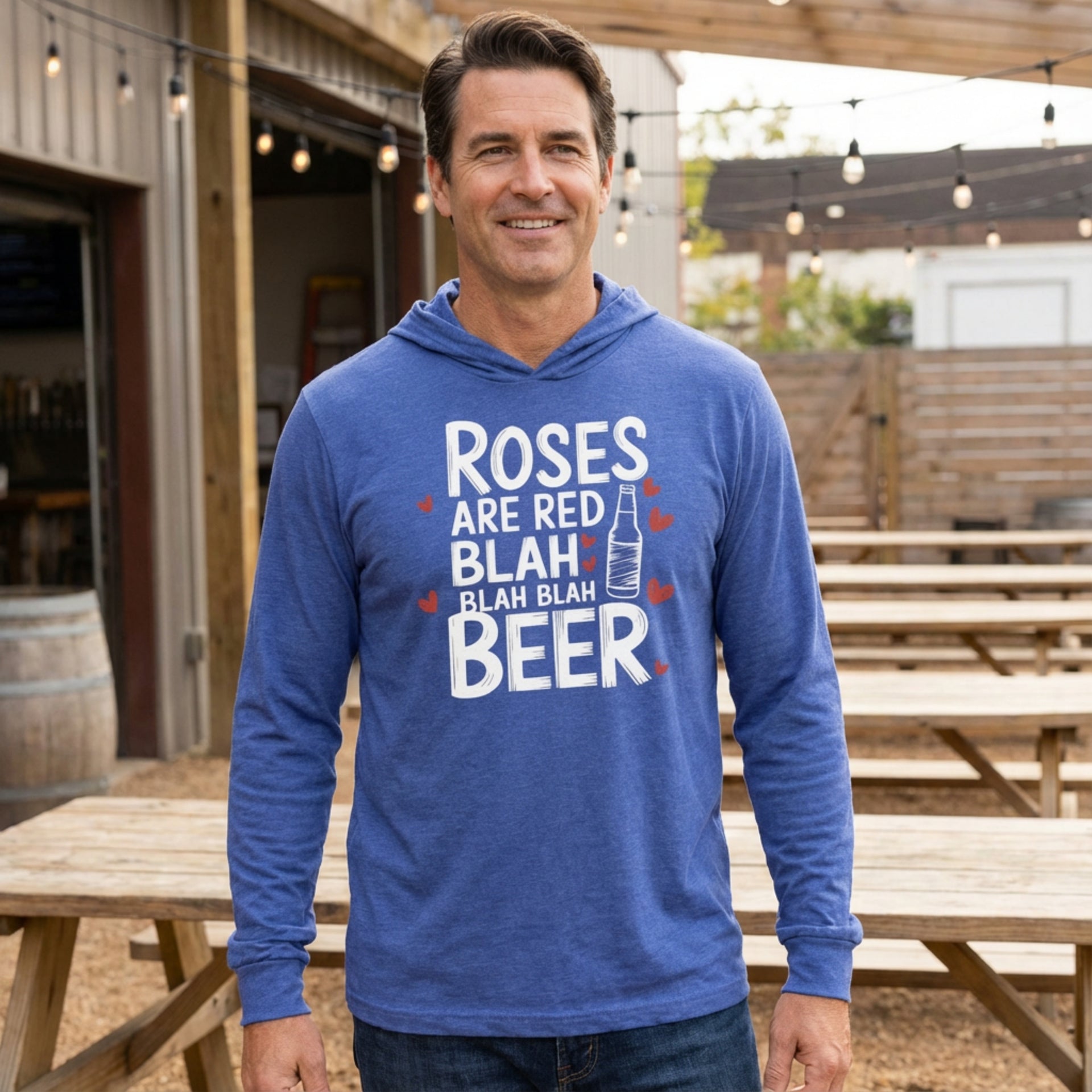 brunette male model wearing featherweight hoodie with the phrase "Rose are Red Blah Blah Blah Beer".  A Sketched Beer bottle and minimalist Valentines Hearts surround the the phrase to complete the design
