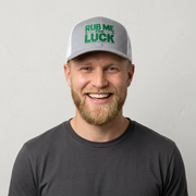 man wearing a gray and white curved bill trucker hat with 'Rub Me for Luck' text funny st patricks day pub crawl design
