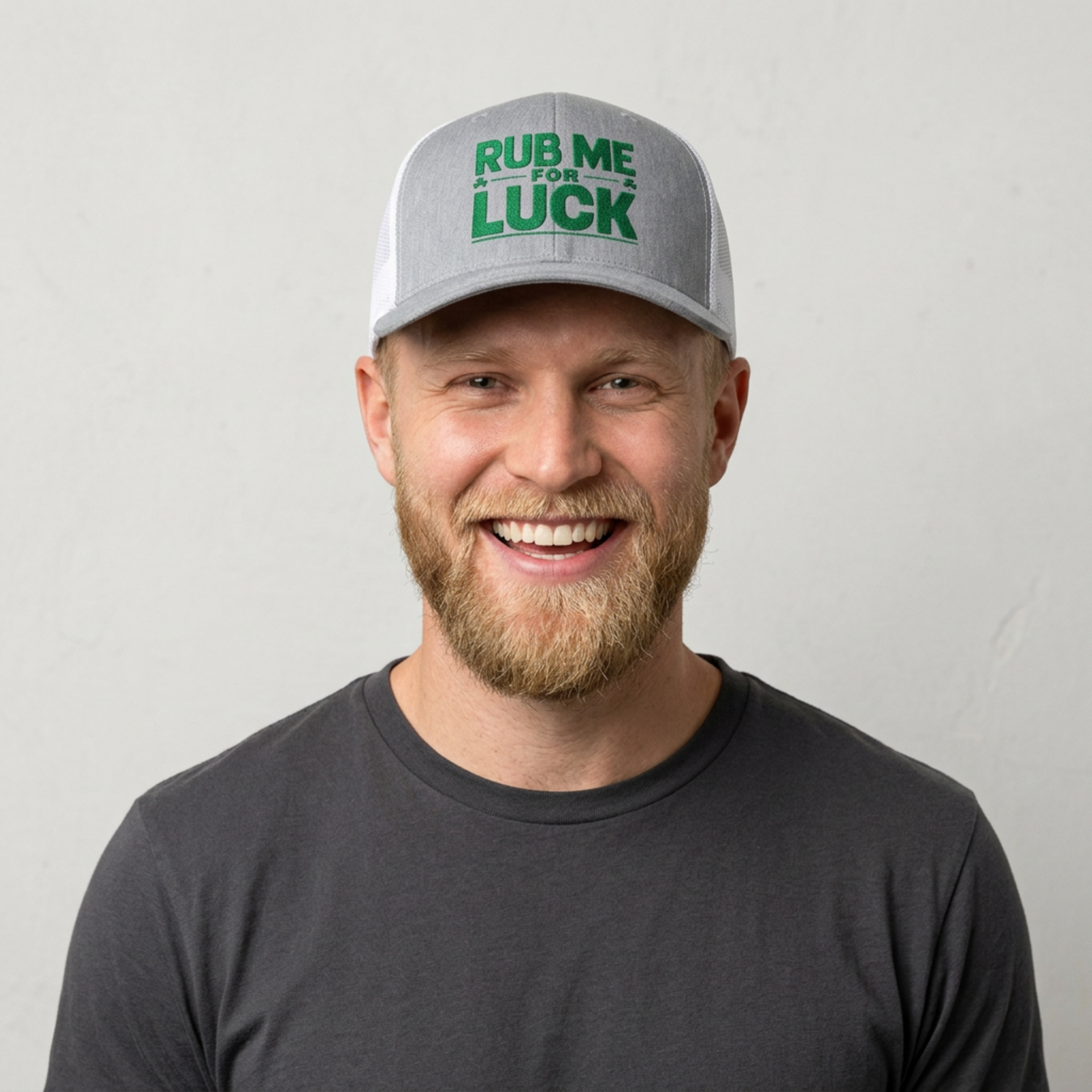 man wearing a gray and white curved bill trucker hat with 'Rub Me for Luck' text funny st patricks day pub crawl design