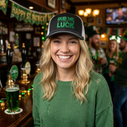 woman wearing a black and white curved bill trucker hat with 'Rub Me for Luck' text funny st patricks day pub crawl design