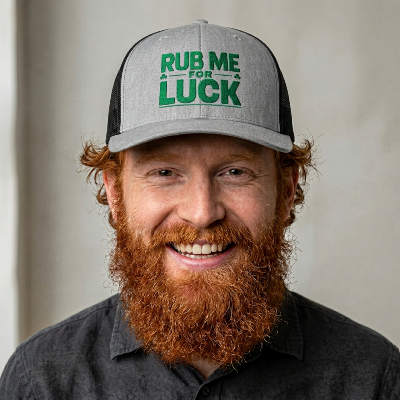 Man wearing a gray and black curved bill trucker hat with 'Rub Me for Luck' text funny st patricks day pub crawl design