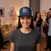 woman wearing a navy  and white premium flat bill trucker hat with the phrase Shit Show Supervisor funny girls trip, beach vacation, spring break, summer vacations, lake days design