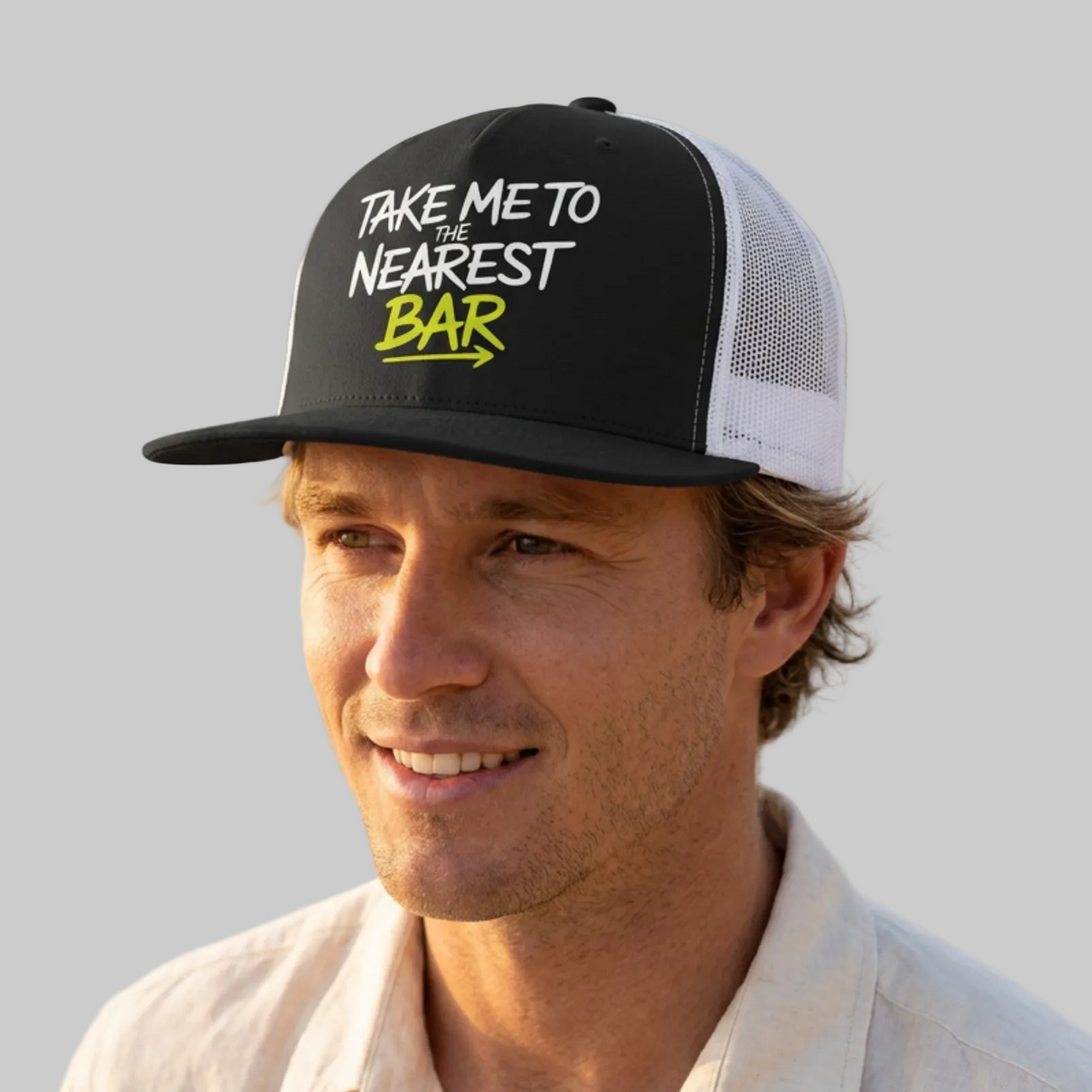 Man wearing a premium black and white trucker hat with 'Take me to nearest bar' text spring break, beach trip, guys trip, girls trip, or beach vacation design