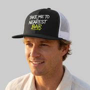 Man wearing a premium black and white trucker hat with 'Take me to nearest bar' text spring break, beach trip, guys trip, girls trip, or beach vacation design