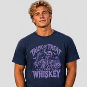 A man wearing a navy blue graphic t-shirt with a purple Halloween design that reads 'TRICK OR TREAT I'LL TAKE A WHISKEY'.