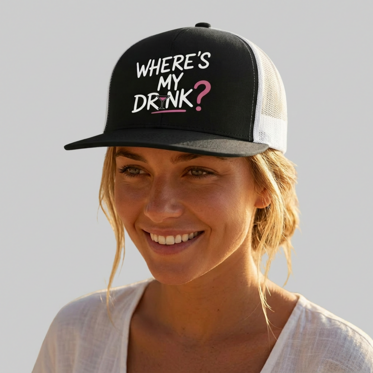 Woman wearing a premium black and white flat bill trucker hat with 'WHERE'S MY DRINK?' text spring break, beach trip, girls trip, summer vacation, bachelorette party design