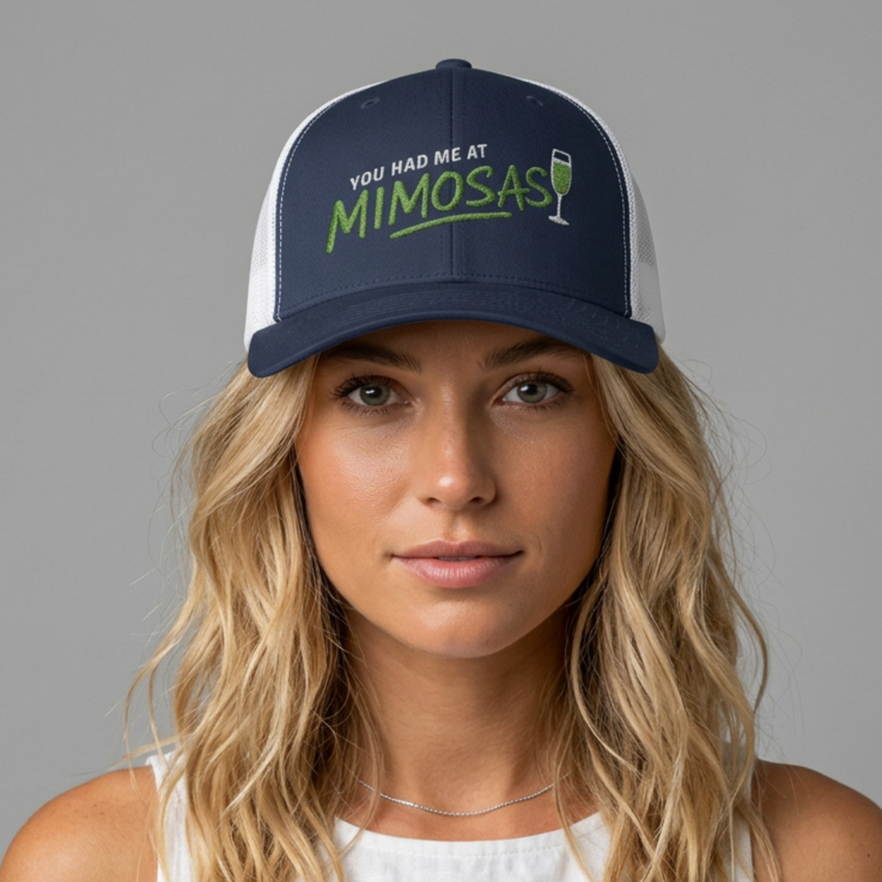Woman wearing a curved bill trucker hat with the phrase'You Had Me at Mimosas' text funny Spring break, girls trip, guys trip, beach trip, summer vacation, lake season design