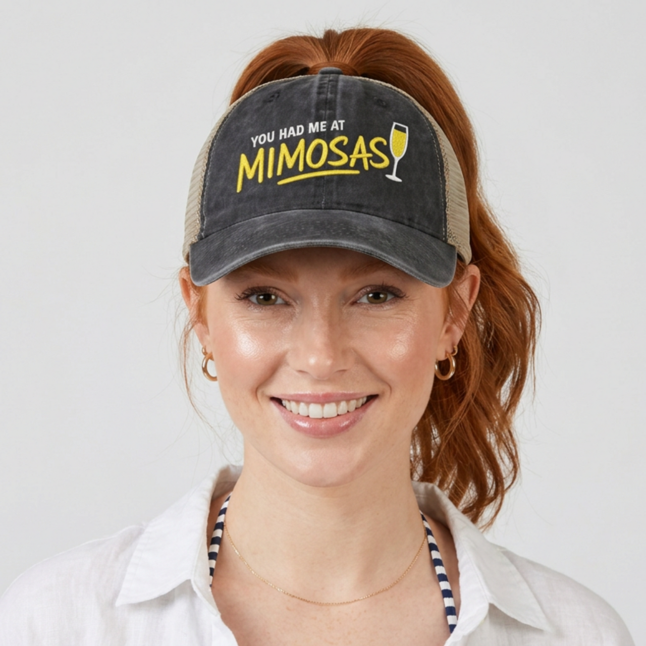Woman wearing a black and khaki ponytail trucker hat with 'You Had Me at Mimosas' text funny spring break, summer vacation, beach trip, lake season, girls trip or bachelorette had
