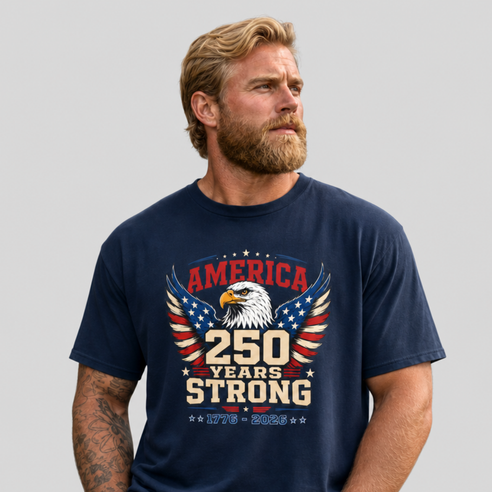 A man wearing a navy blue T-shirt with an eagle graphic and '250 Years Strong' text, patriotic 4th of July, America 250 design