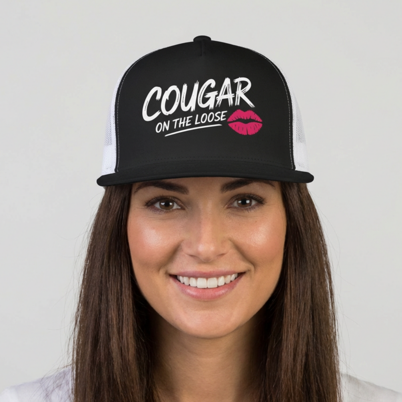 Woman wearing a black and white flat bill trucker hat with the phrase 'Cougar on the Loose' funny beach trip, girls trip, bachelorette party, or spring break design