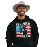 4th of July Hoodie with '100% American Drunkard' text, man drinking a bottle of beer wearing a trucker hat, and distressed American flag background