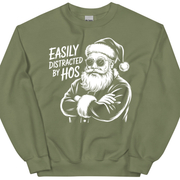 Green sweatshirt with a graphic of a man in a Santa hat and sunglasses and text 'Easily Distracted by Hos'.