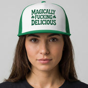 Person wearing a cap with 'MAGICALLY FUCKING DELICIOUS' text on a plain background