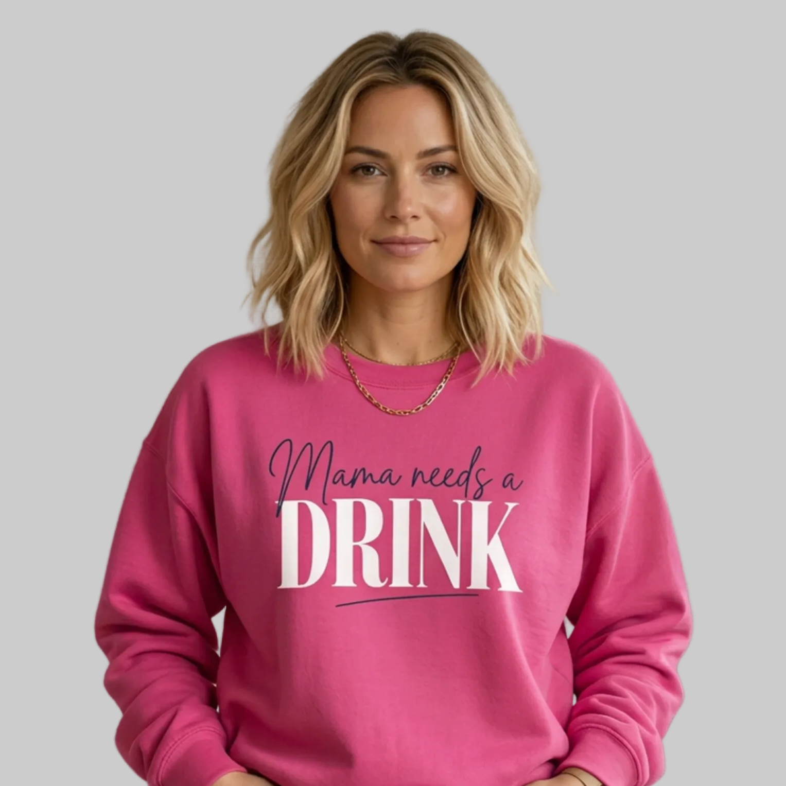 Woman wearing a pink sweatshirt with 'Mama needs a DRINK' text funny mother's day, mom life, girls trip design