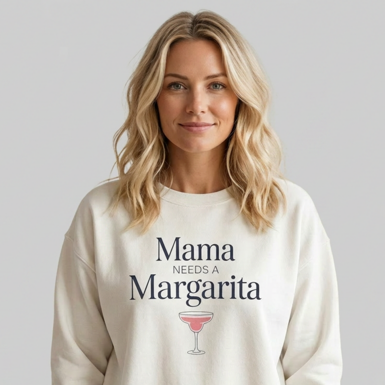 Woman wearing a white sweatshirt with 'Mama Needs a Margarita' text funny mothers day, beach trips, girls trips, mom life design