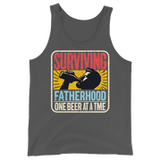 Celebrate fatherhood with our "Surviving Fatherhood One Beer at a Time" tank top. Perfect gift for dads who love a cold one. Ideal gift for Father's Day.