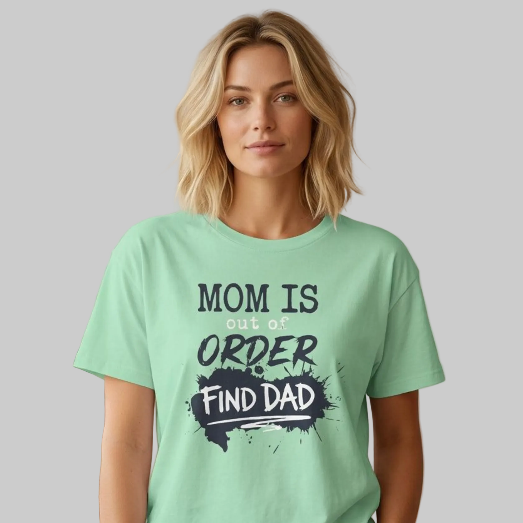 woman wearing a mint green premium soft-style t-shirt with text 'Mom is out of order find dad' funny mother's day, mom life, beach trip design