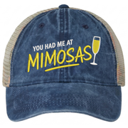 a navy and khaki ponytail trucker hat with 'You Had Me at Mimosas' text funny spring break, summer vacation, beach trip, lake season, girls trip or bachelorette had