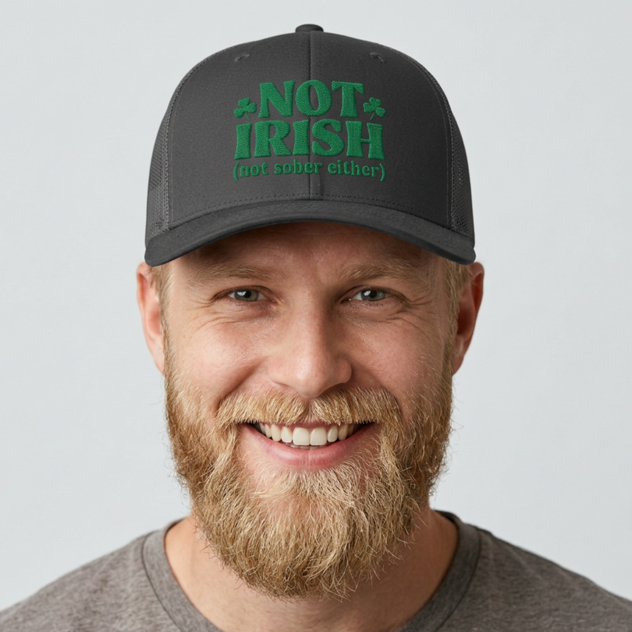 Man wearing a black and gray curved bill trucker hat with 'Not Irish (not either other)' text funny St Patricks Day pub crawl design