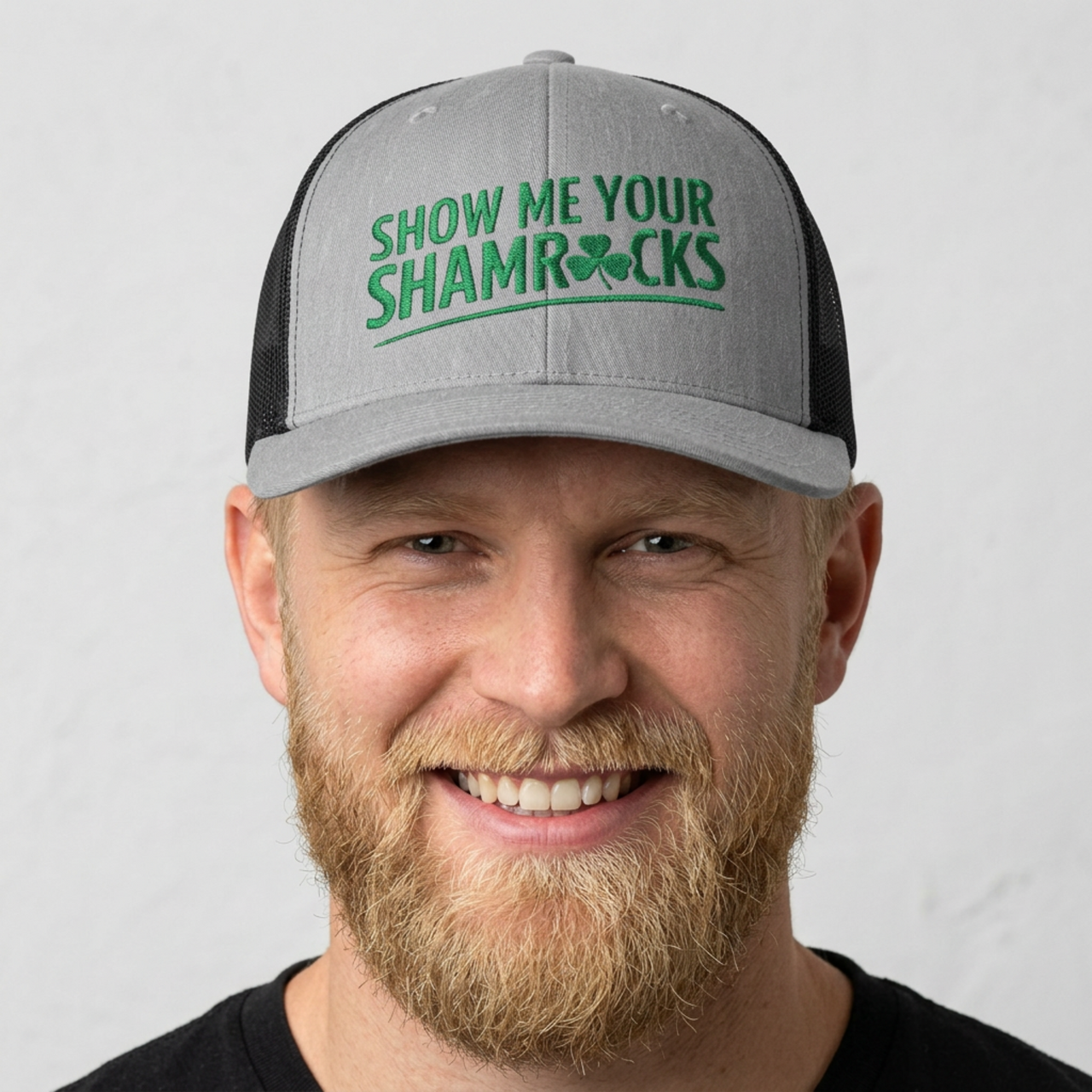 Man wearing a gray and black curved trucker hat with 'Show Me Your Shamrocks' text funny st patricks day pub crawl design