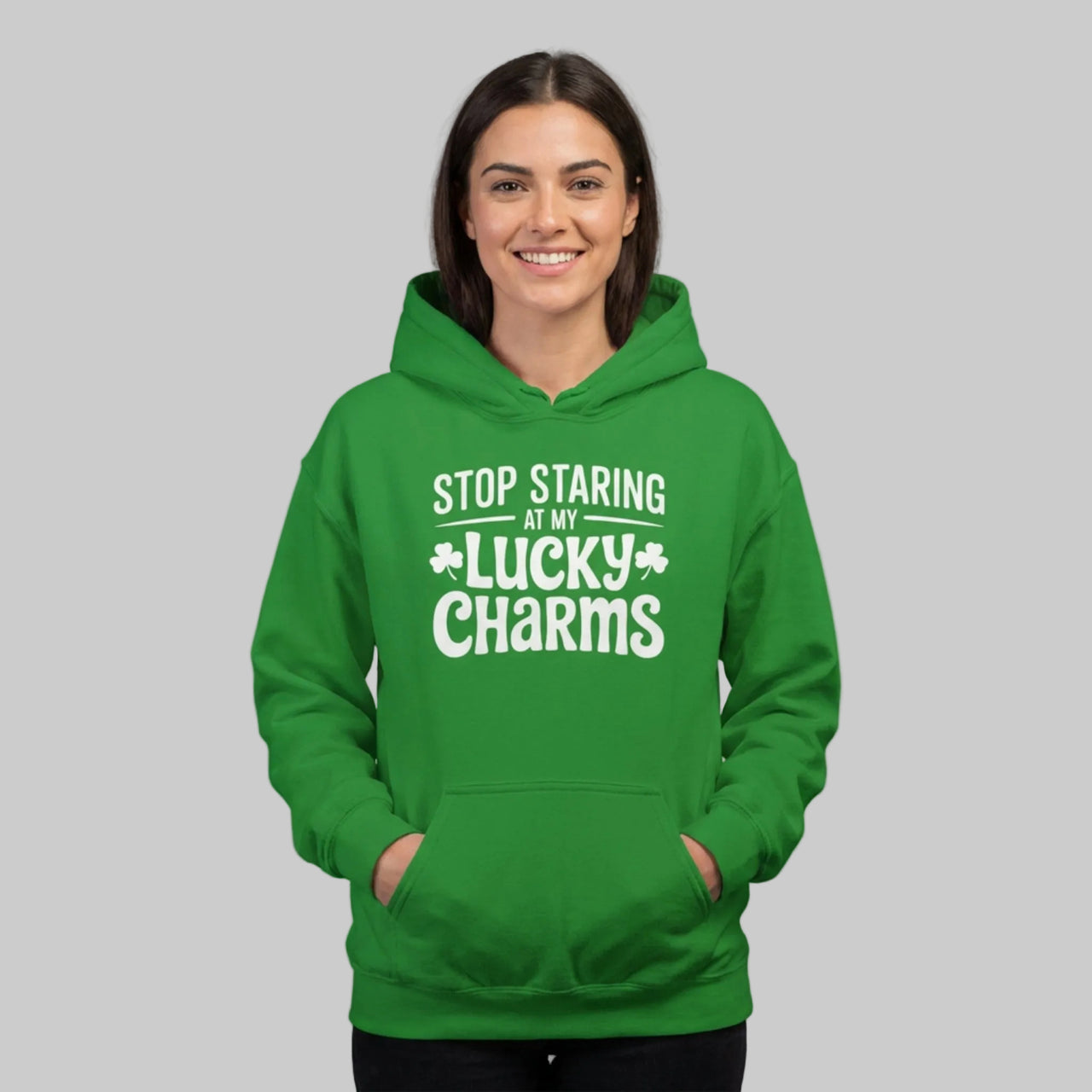 Woman wearing a green hoodie with the phrase stop staring at my lucky charms funny st patricks day design