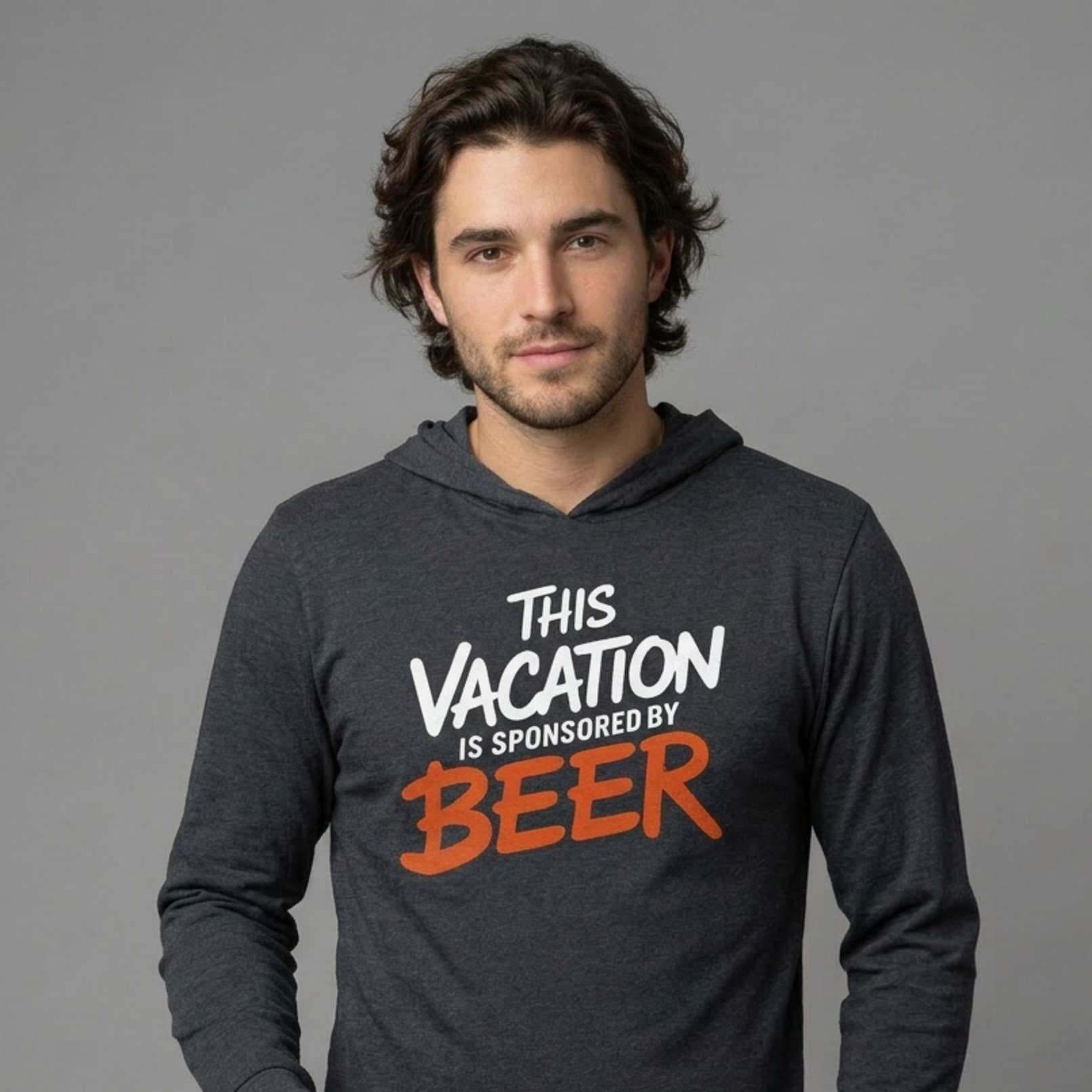 Man wearing a heather navy lightweight hoodie with text 'This vacation is sponsored by beer' funny spring break,beach trip, lake season, or bachelor bachelorette trip design