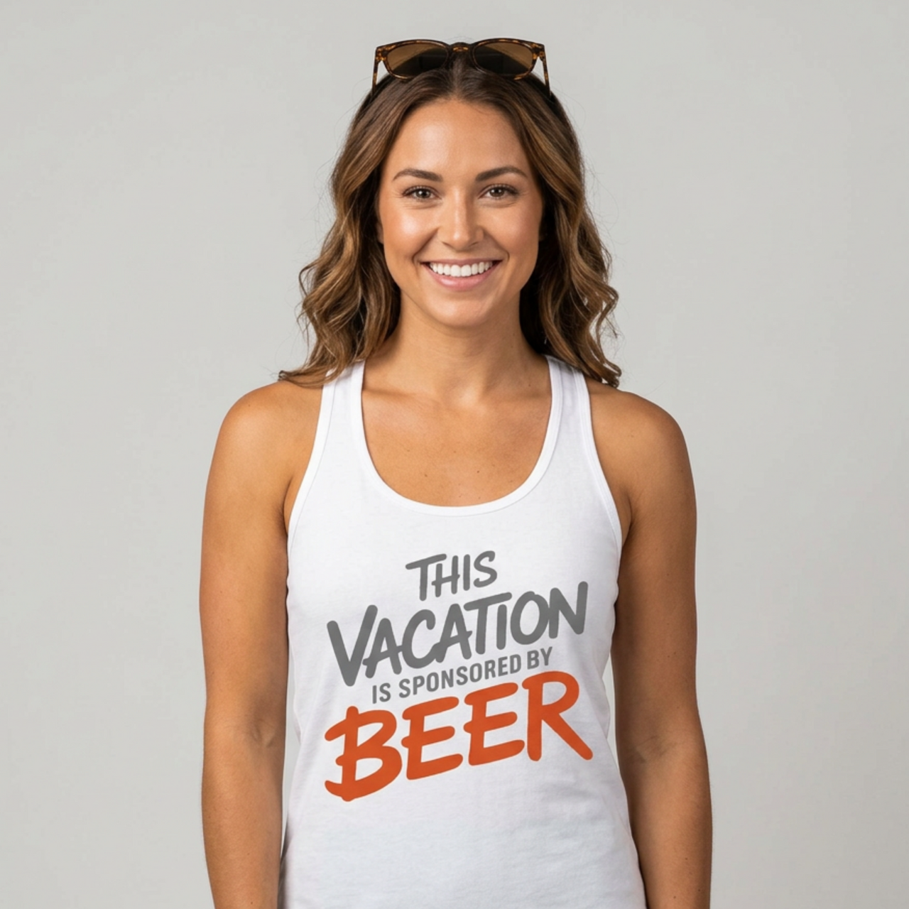 Woman wearing a white racerback tank top with 'This Vacation is Sponsored by Beer' text funny spring break, beach trip, bachelorette party, girls trip, or lake season design