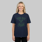 woman wearing a navy blue t-shirt with 'Tini Bit Irish' text and martini glass funny st patricks day design