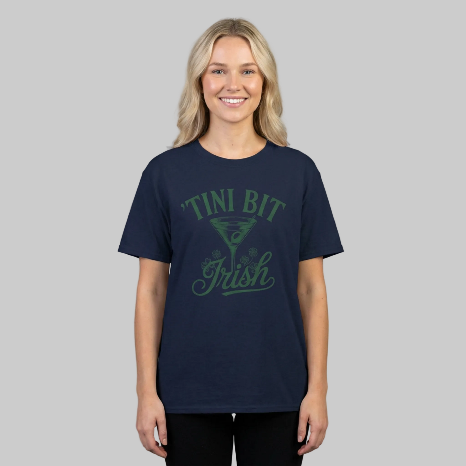 woman wearing a navy blue t-shirt with 'Tini Bit Irish' text and martini glass funny st patricks day design