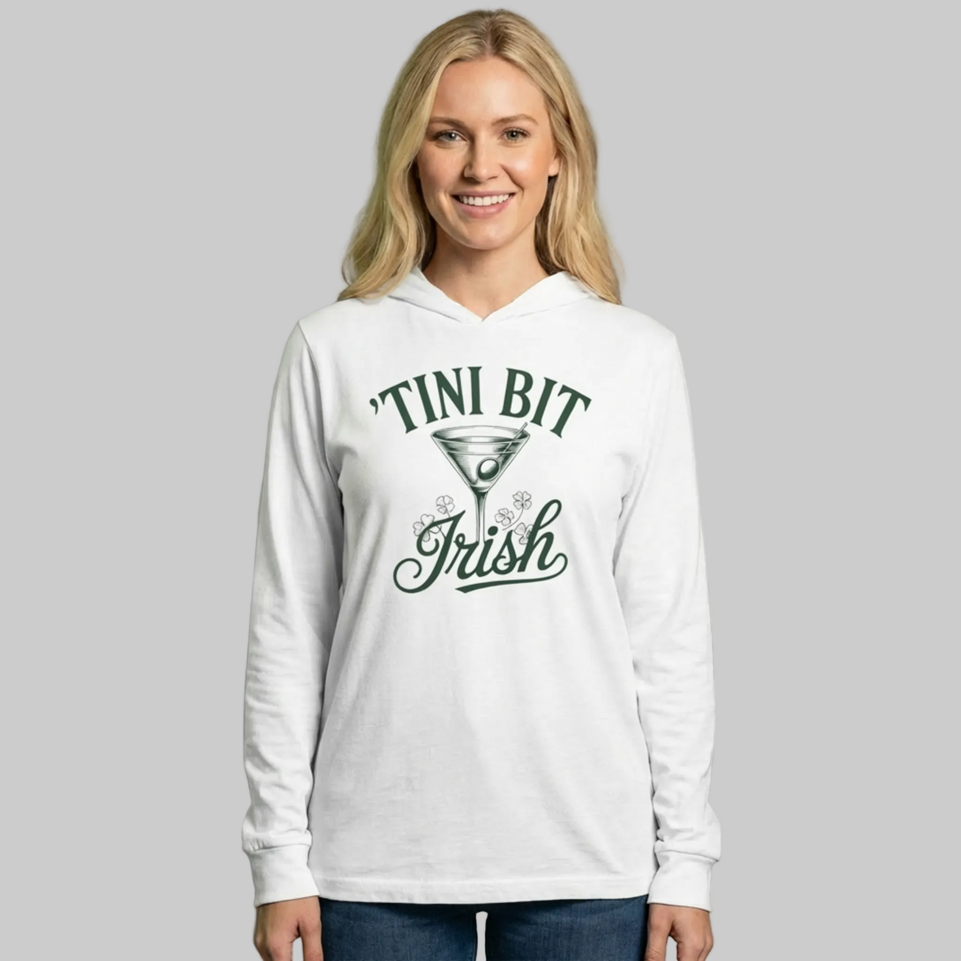 Woman wearing a white lightweight hoodie with 'TINI BIT IRISH' text and martini glass design funny st patricks day design