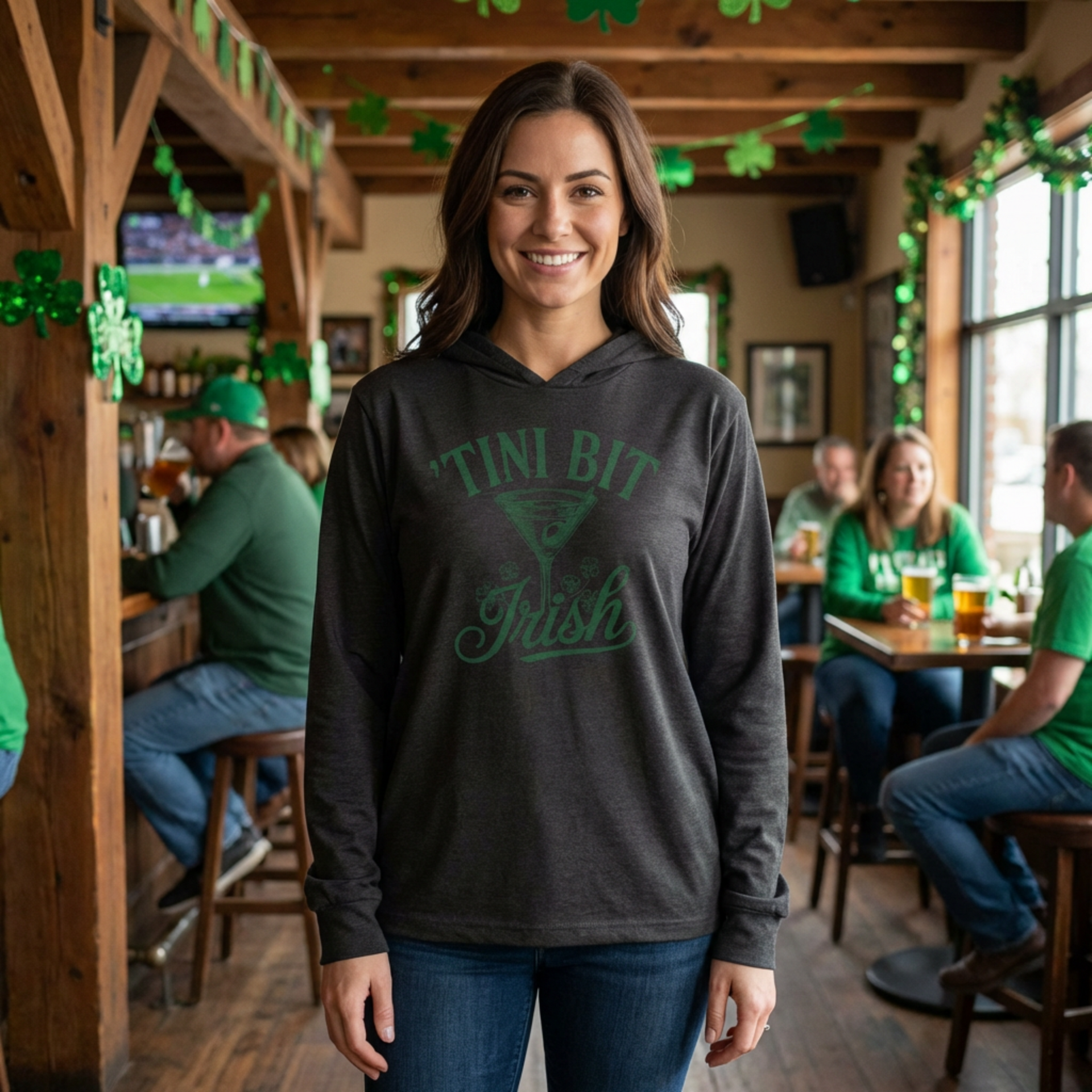 woman wearing a black lightweight hoodie with 'TINI BIT IRISH' text and martini glass designfunny st patricks day design