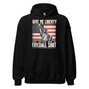 Hoodie with 'Give Me Liberty or Give Me a Fireball Shot' text, Statue of Liberty holding a shot glass, and distressed American flag background. Perfect for 4th of July.